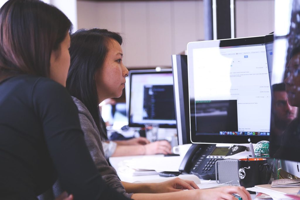 two tech women at computer